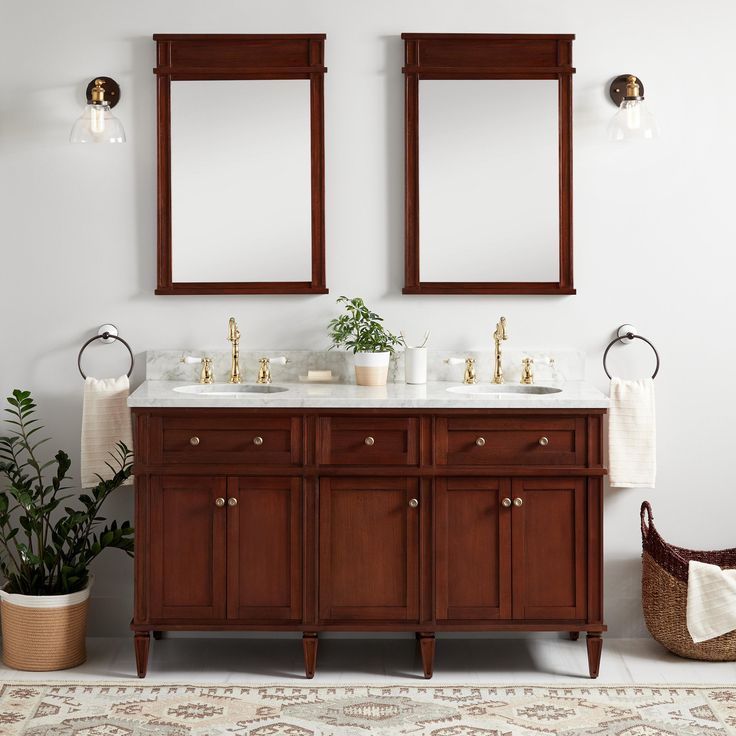 a bathroom with two mirrors above the sinks and a rug on the floor next to it