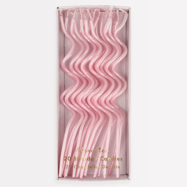 pink plastic straws in a box on a white background