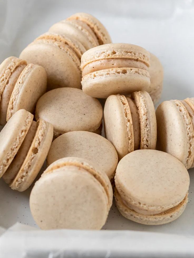 a pile of macaroons sitting on top of a white plate