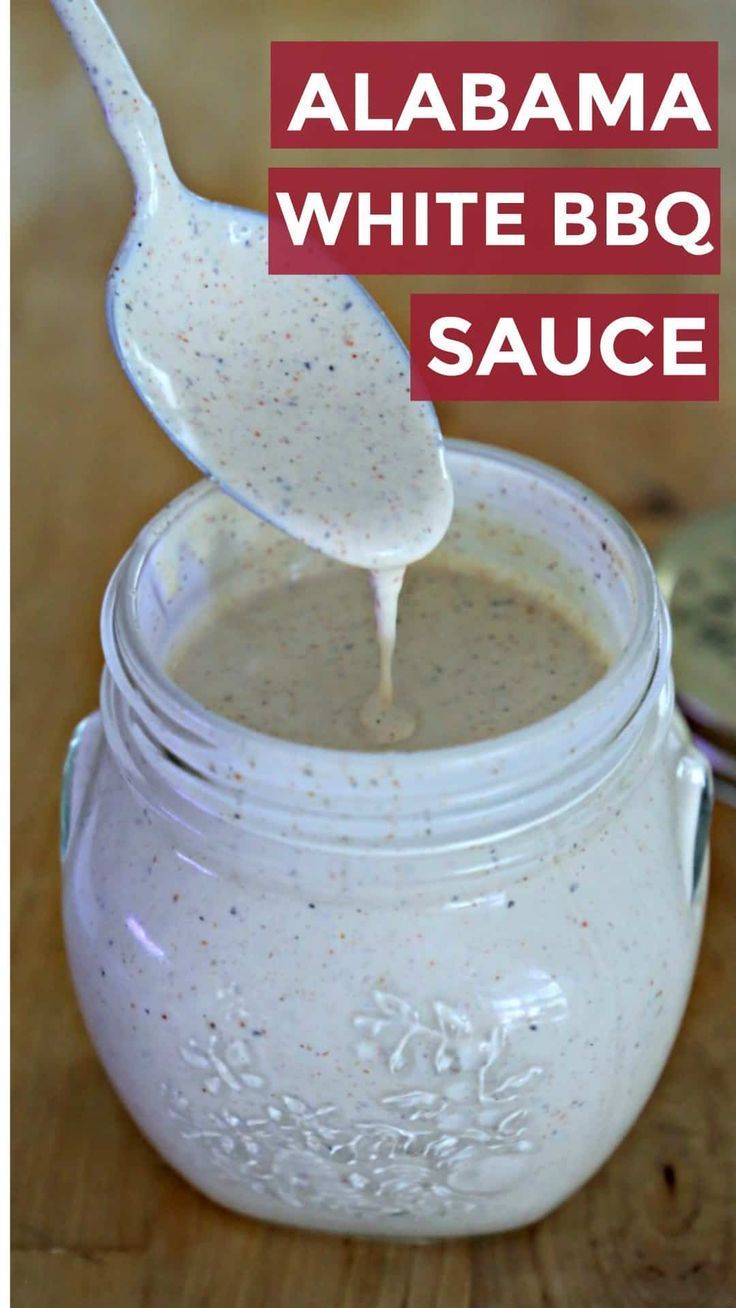 white bbq sauce in a mason jar with a spoon