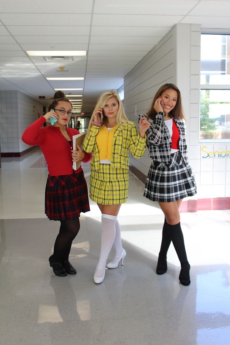 three women dressed in costumes posing for the camera