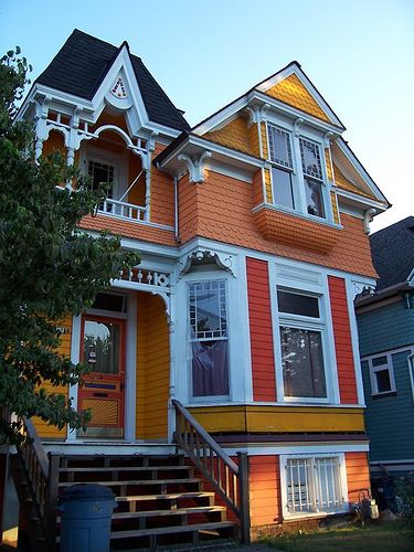 an orange and white house with stairs leading up to it