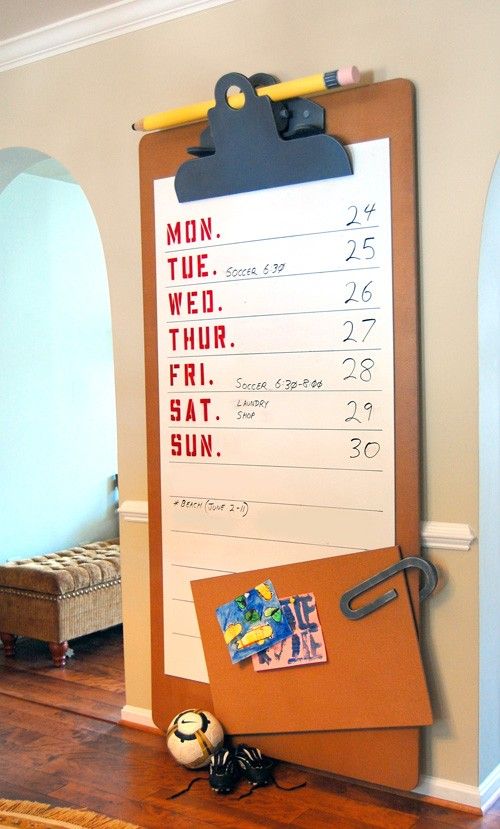 a bulletin board on the wall in a room with wood flooring and blue walls