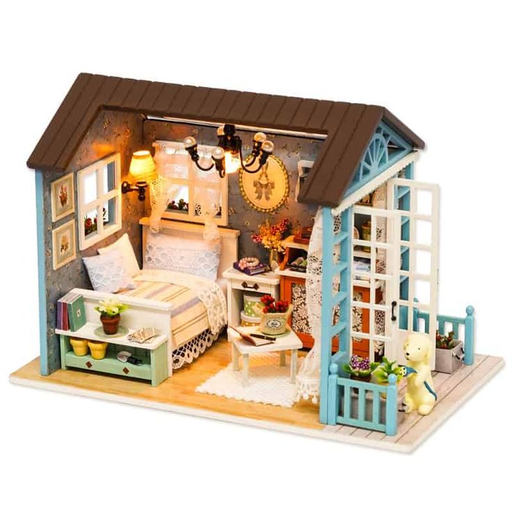 a doll house with furniture and accessories in the room, including a bed, desk, chair, window, lamp and teddy bear