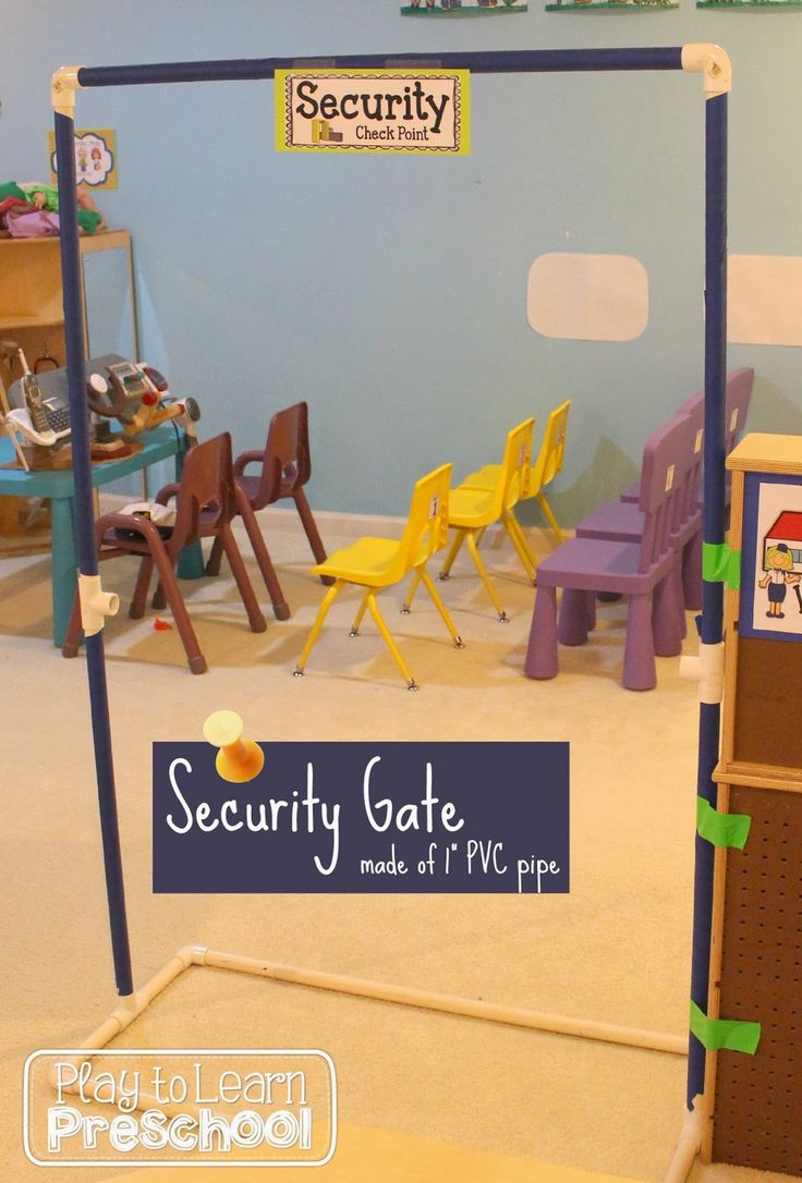 there is a security gate in the middle of a room with chairs and desks