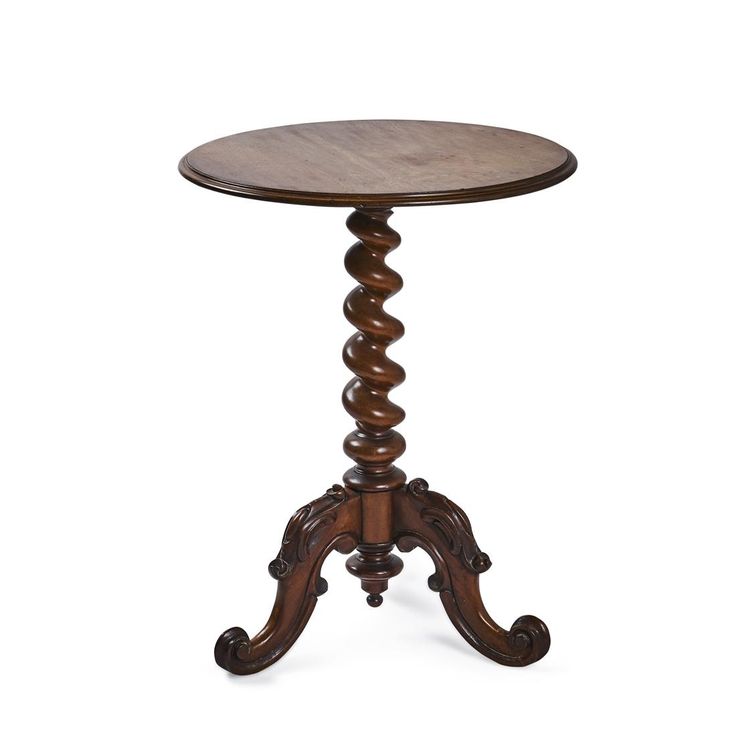 a small wooden table with an ornate design on the top and bottom, sitting against a white background