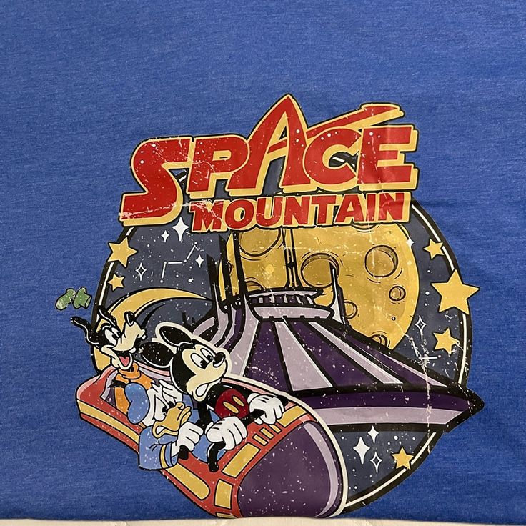 New Without Tags. Never Worn. Blue Tshirt With Mickey Space Mountain Design On The Front. Retro Style. Lightweight Soft Material Disney T-shirt With Cartoon Print For Disney Trips, Fun Letter Print T-shirt For Disney Trips, Crew Neck Cotton Tops For Theme Park, Cotton Crew Neck Top For Theme Park, Casual Crew Neck Tops For Theme Park, Blue Short Sleeve Themed Tops, Disney Graphic Print T-shirt For Disney Trips, Casual Tops With Character Print For Theme Park, Cotton Graphic Print Tops For Theme Park