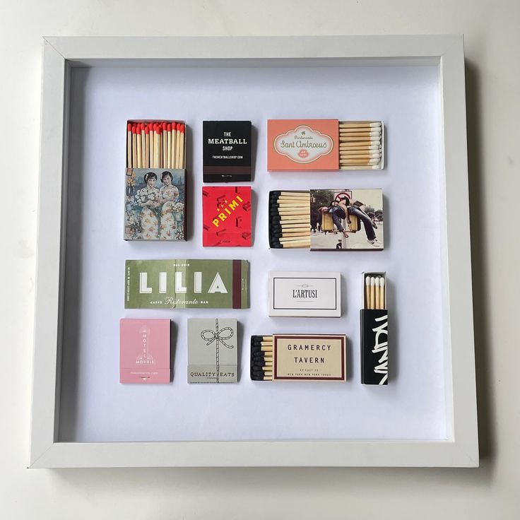 a shadow box with matchboxes and matches in it