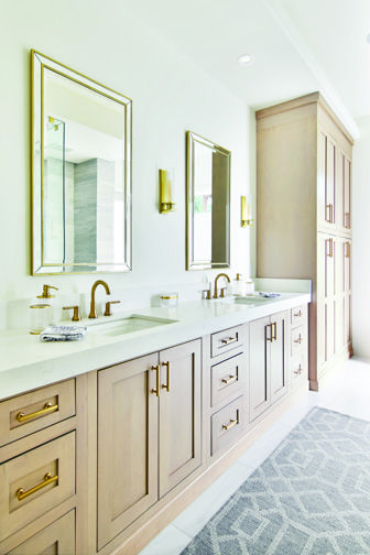 a large bathroom with double sinks and mirrors