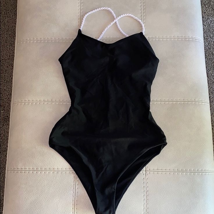 Black With White Straps Super Sexy Cut Has Padding For Additional Support Quick Dry Material Can Be Worn As Swimsuit Or Bodysuit Size S Black Backless Leotard For Swimming, Summer Black Backless Leotard, Black Backless Leotard For Summer, Backless Black Leotard For Summer, Black Backless Summer Leotard, Black Beach Leotard With Lined Body, Beach Black Leotard With Lined Body, Black Beachwear Leotard For The Beach, Black One-piece Leotard For Beach