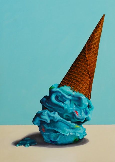 an ice cream cone with blue icing on it's tip is sitting in front of a blue background