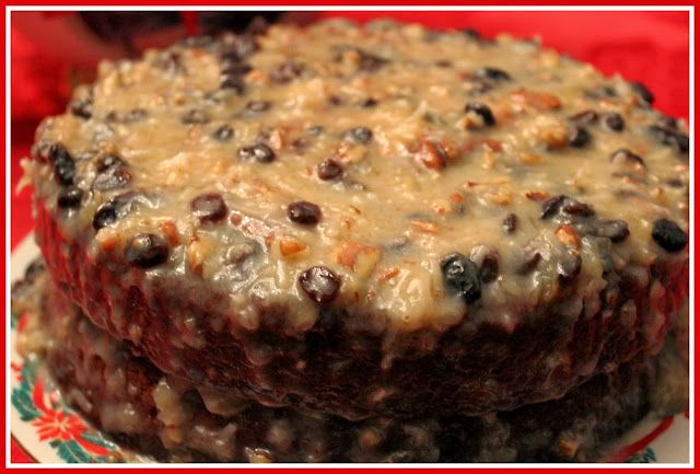 a close up of a cake on a plate with chocolate chips and raisins