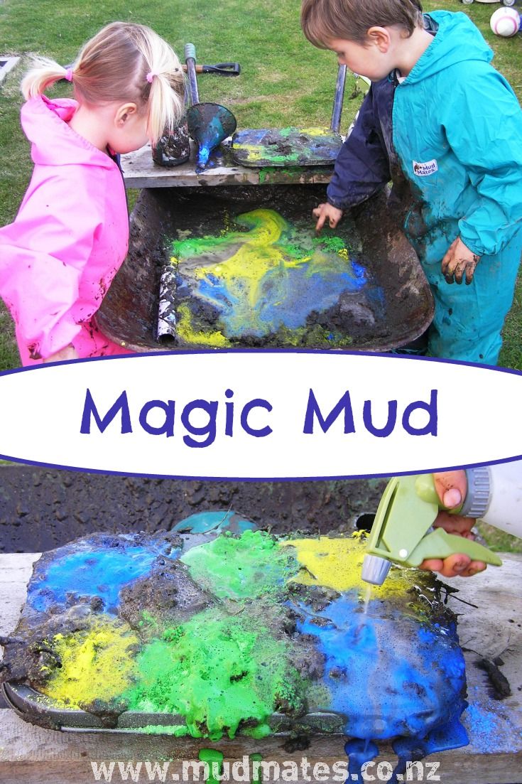 two children are playing with colorful mud in the grass, and one child is holding a shovel