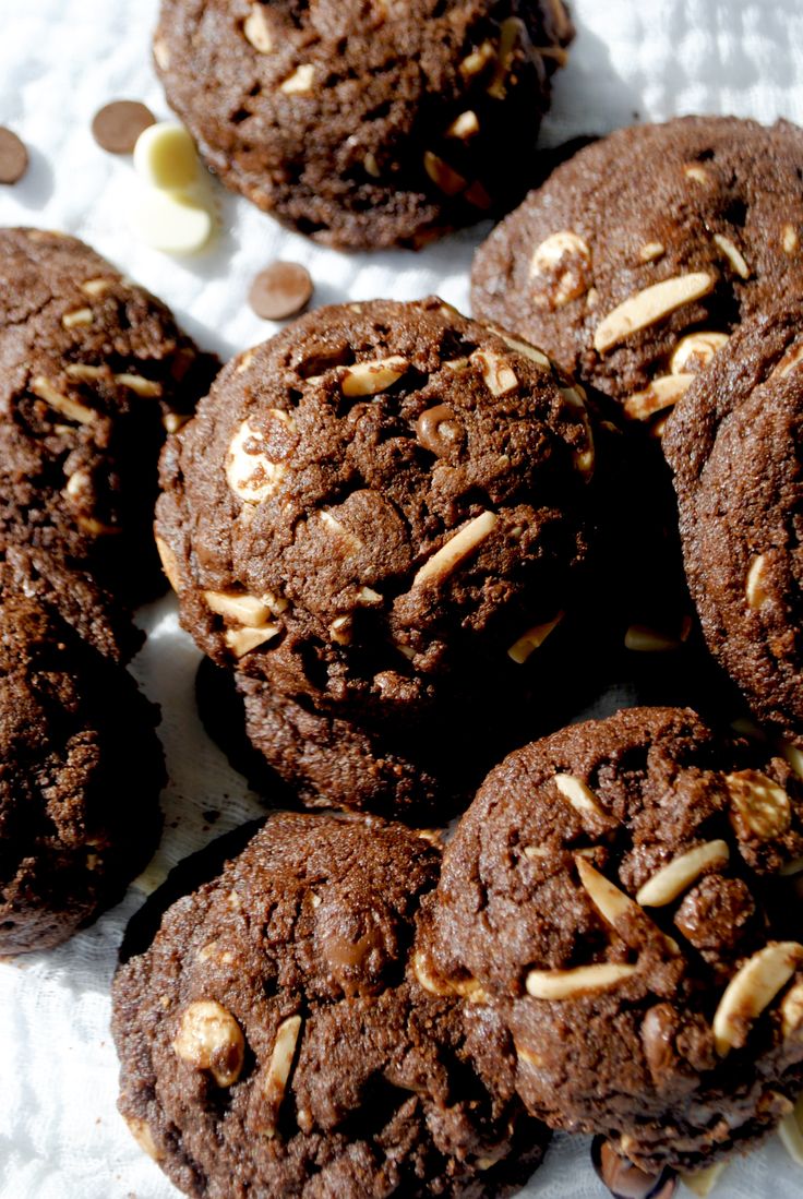 several chocolate cookies with nuts on top of them