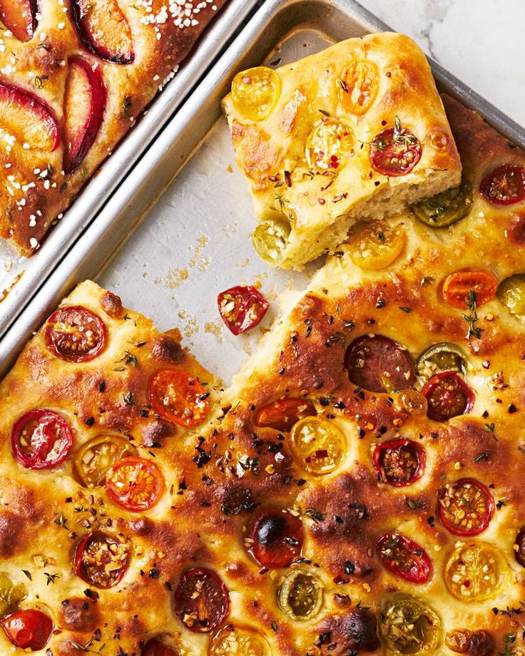 two pizzas with different toppings sitting on top of pans next to each other