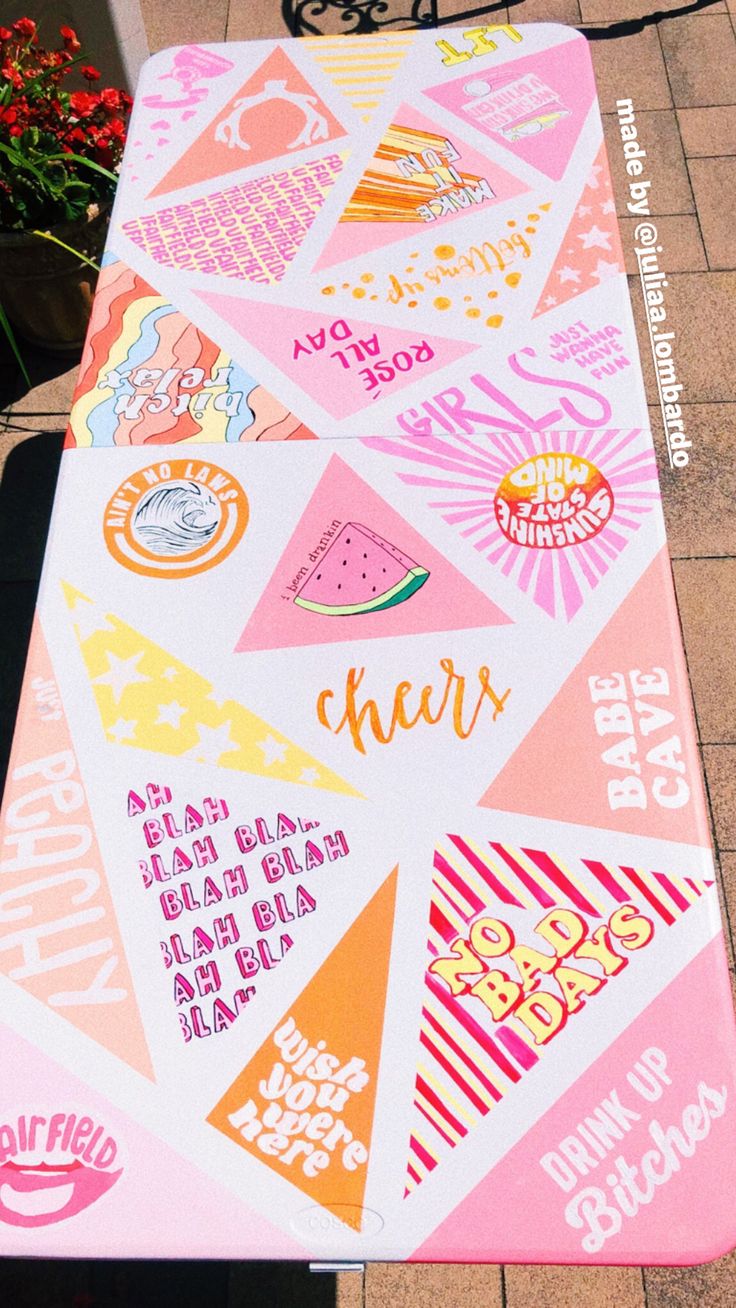 a pink and yellow picnic mat with different designs on it