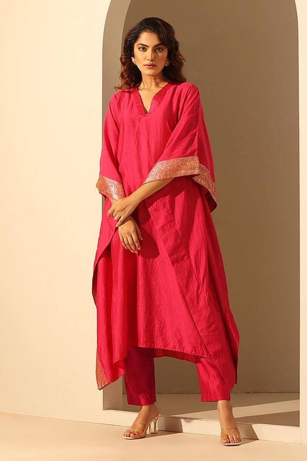 Pink handloom chiniya silk kaftan with sequins embroidery. Comes with a pant.
Components: 2
Pattern: Hand embroidered
Type Of Work: Sequins
Neckline: V Neck
Sleeve Type: Flared Sleeves
Fabric: Handloom chiniya silk
Color: Pink
Other Details: 
Length :
Kaftan : 48 inches
Sleeve : 11 inches
Pant : 37 inches
Model Height : 5 ft 6 inches, wearing size S
Occasion: Sangeet - Aza Fashions V Neck Kaftan, Kaftan For Women, Silk Kaftan, Types Of Work, Sequins Embroidery, Pant Set, Flared Sleeves, Aza Fashion, Model Height