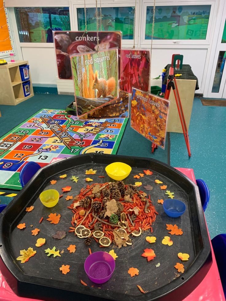 a child's play area with toys and books on the table in front of them