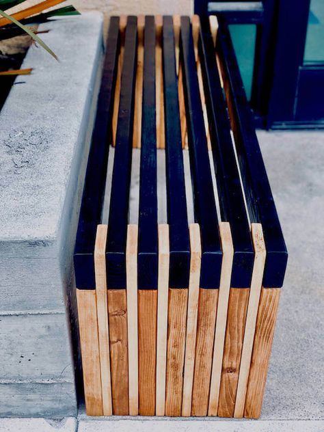 a wooden bench sitting on top of a sidewalk