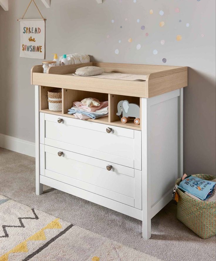 a baby's room with a crib and dresser