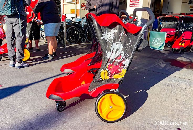 a mickey mouse stroller is parked on the street