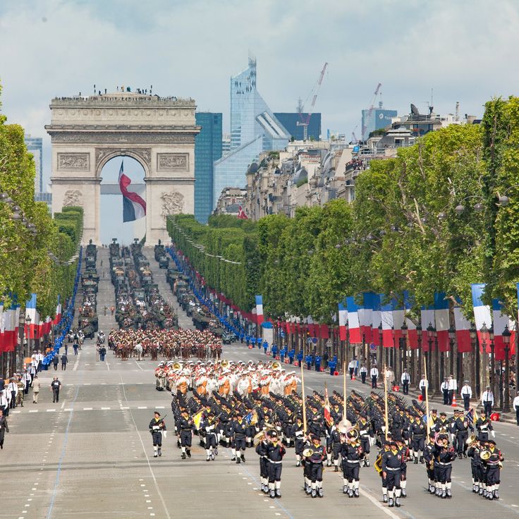 a group of people in uniform marching down the street