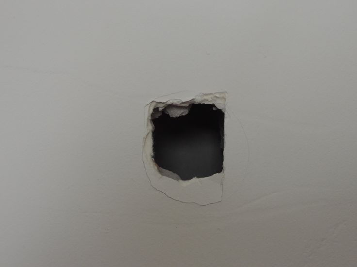 a hole in the wall that has been painted white