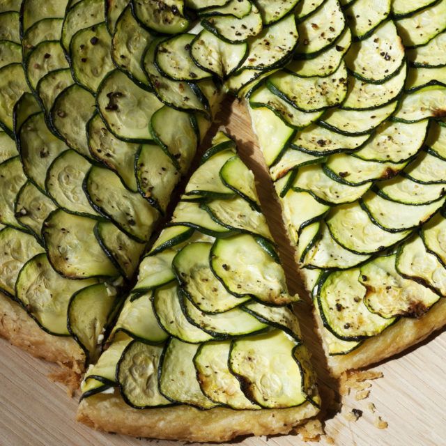 a pizza with zucchini slices cut in half