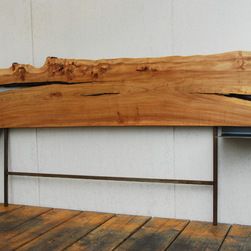 a piece of wood sitting on top of a wooden floor next to a wall with white walls