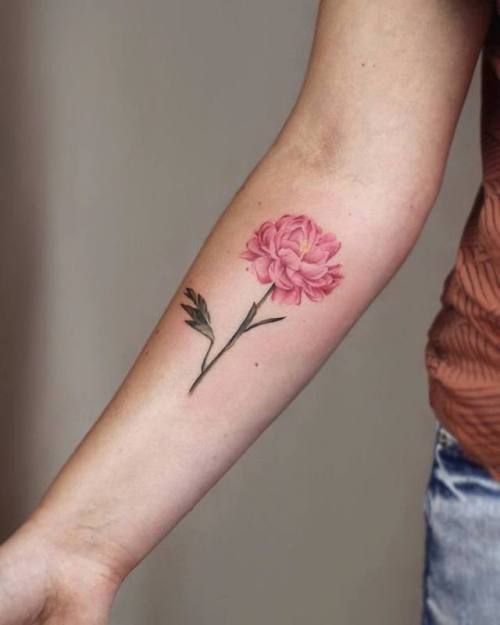 a woman with a pink flower tattoo on her arm