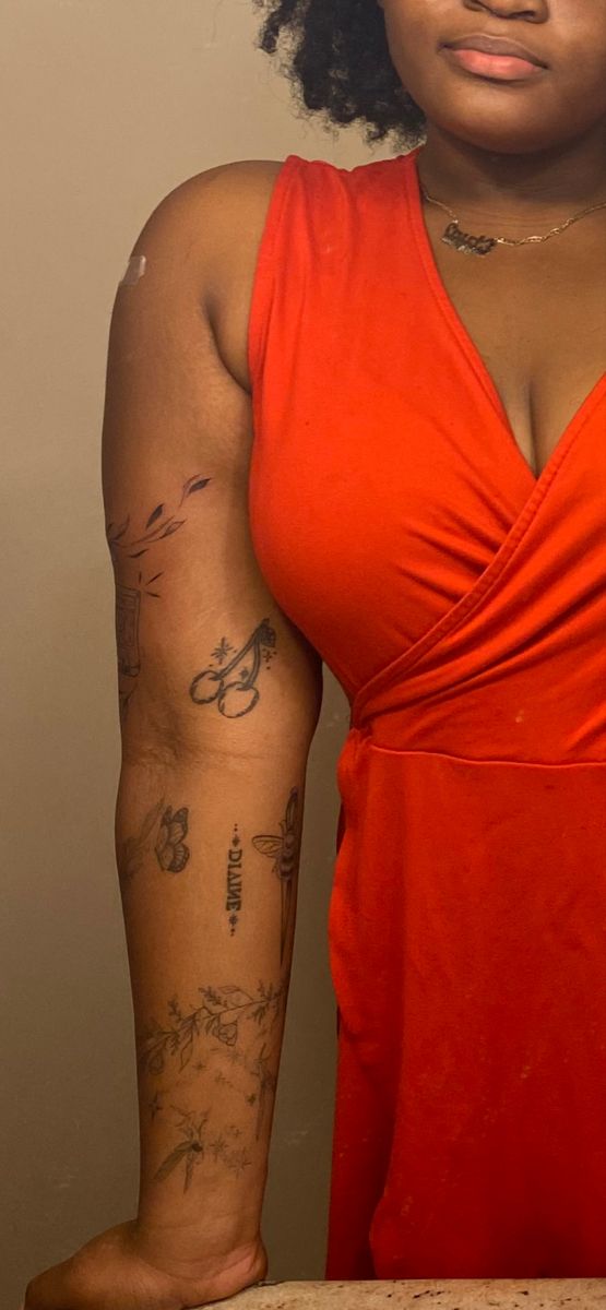 a woman with tattoos on her arm posing for the camera