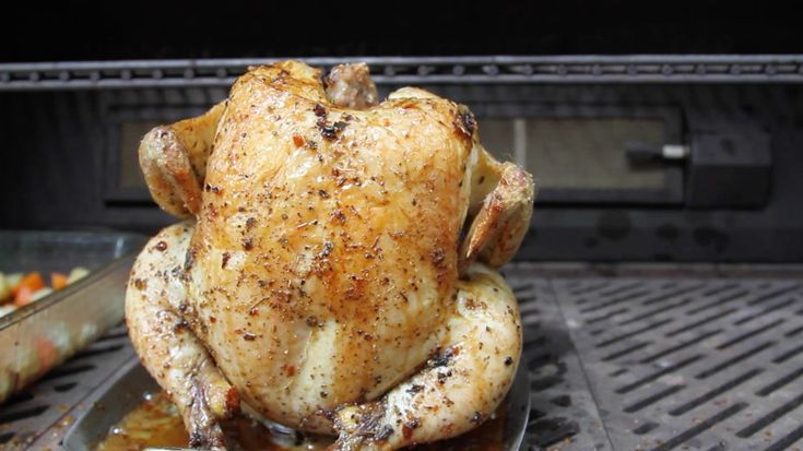 a cooked chicken sitting on top of a grill