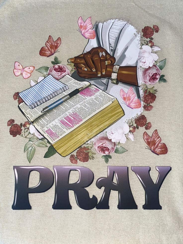 a t - shirt with the words pray surrounded by flowers and an image of a book