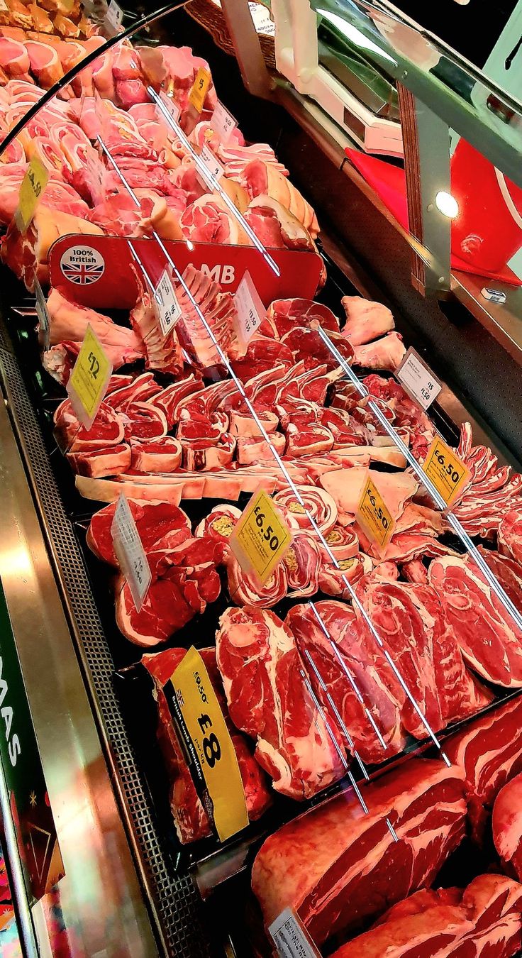 the meat section of a grocery store with various cuts of meat on display for sale