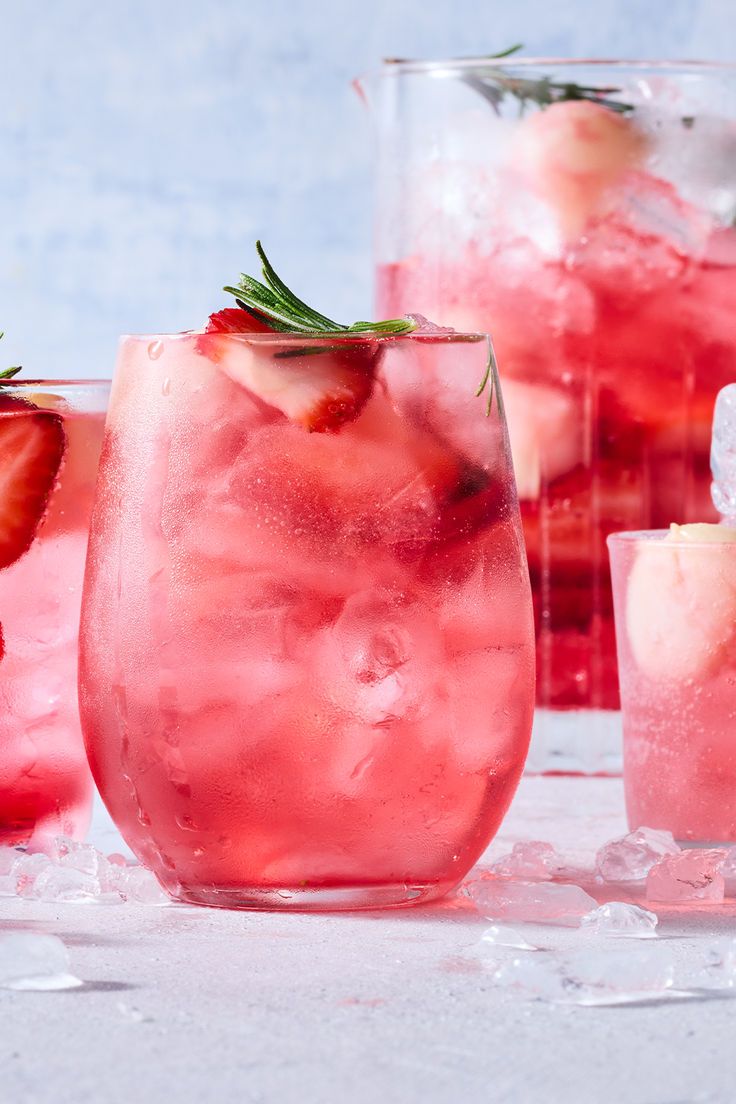 three glasses filled with ice and strawberries