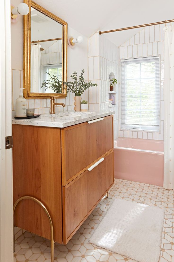 a bathroom with a sink, mirror and bathtub