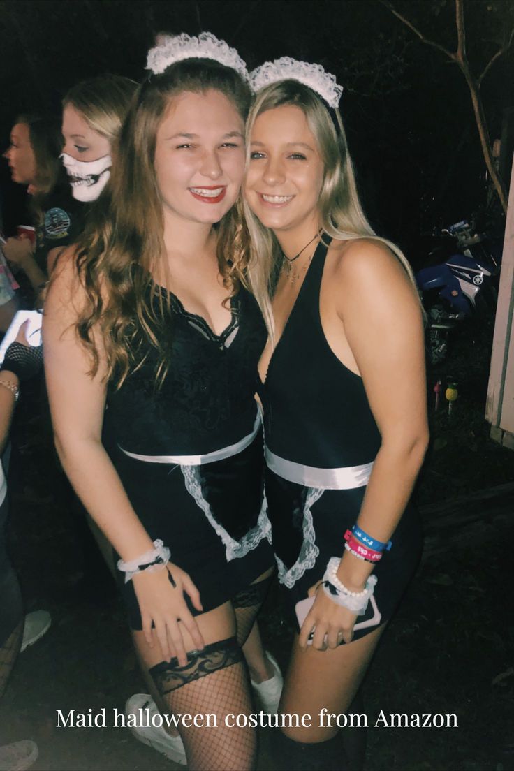 two young women dressed in costumes posing for a photo