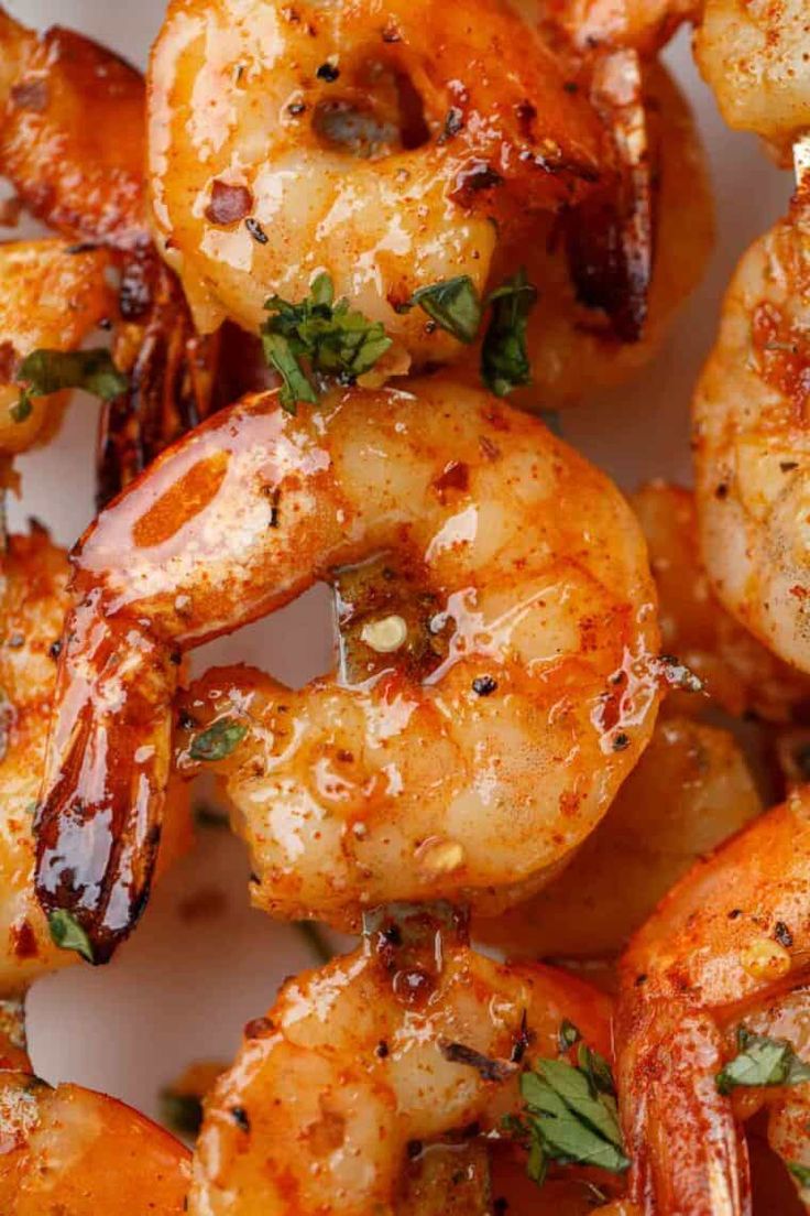 grilled shrimp with herbs and seasoning on a white plate