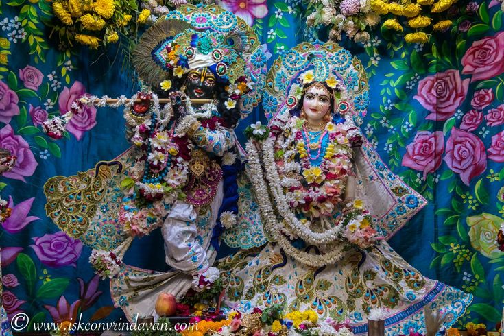 an idol is displayed in front of a colorful backdrop with flowers and other decorations on it