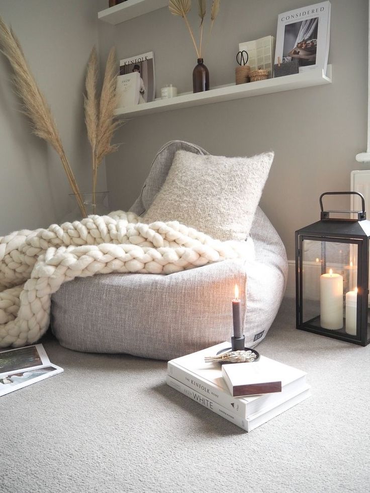 a living room with a bean bag chair and candles