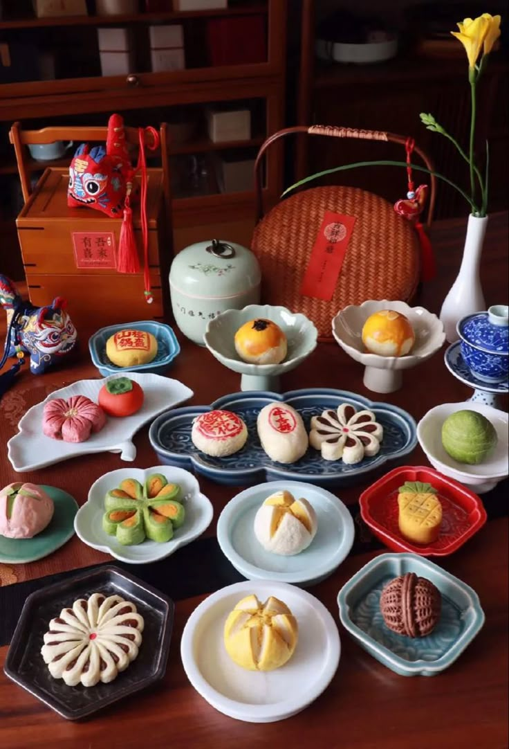 a table topped with plates and bowls filled with desserts