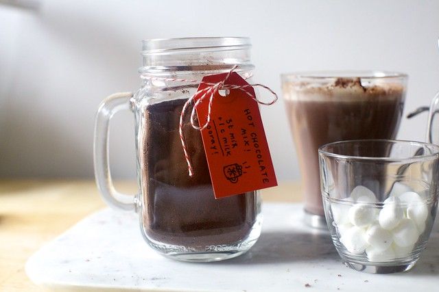 there are three different kinds of drinks in the jars on the table, one is hot and one is cold