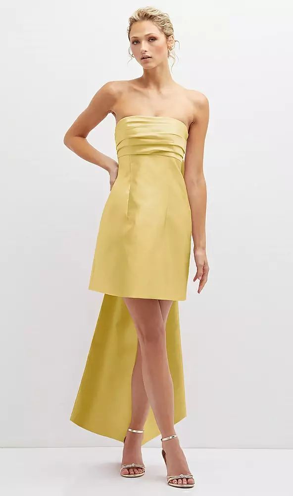 a woman in a strapless yellow dress poses for the camera with her hands on her hips