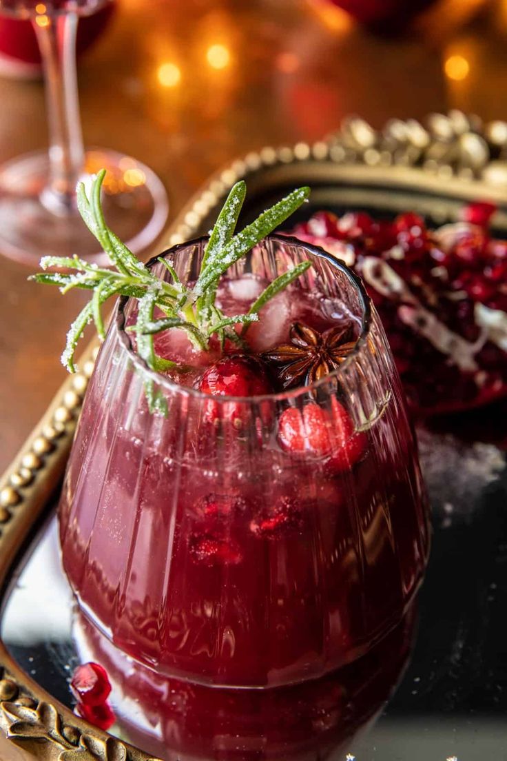 a glass filled with red liquid on top of a tray