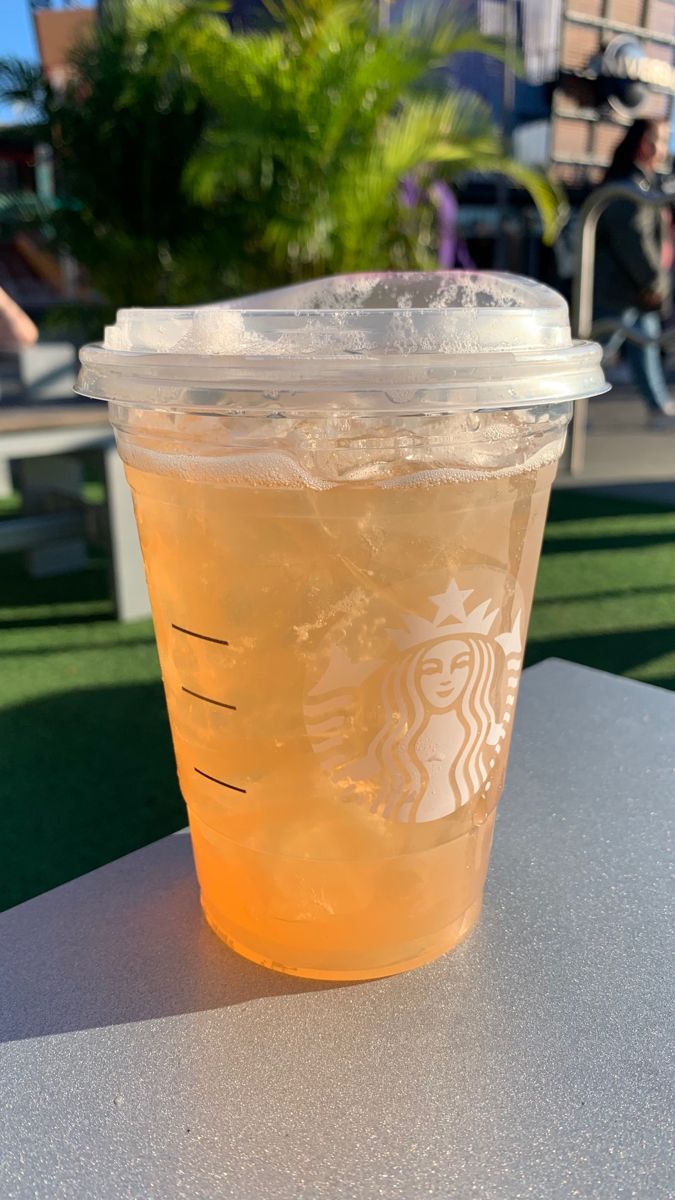 a cup of iced tea sitting on top of a table