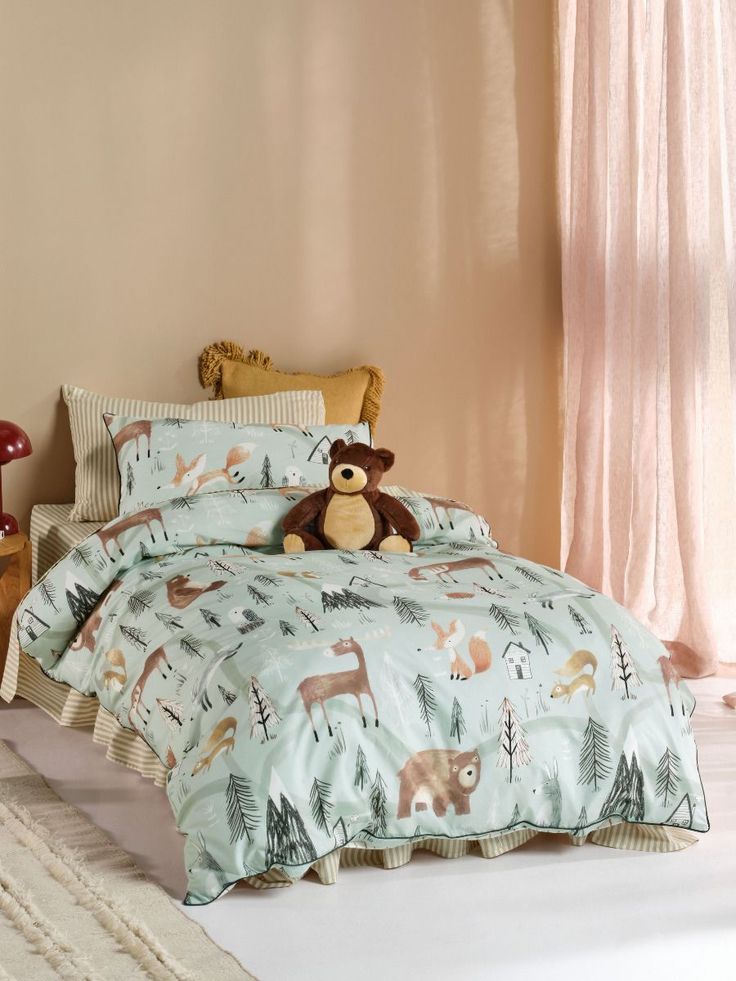 a teddy bear sitting on top of a bed in a room with pink walls and curtains