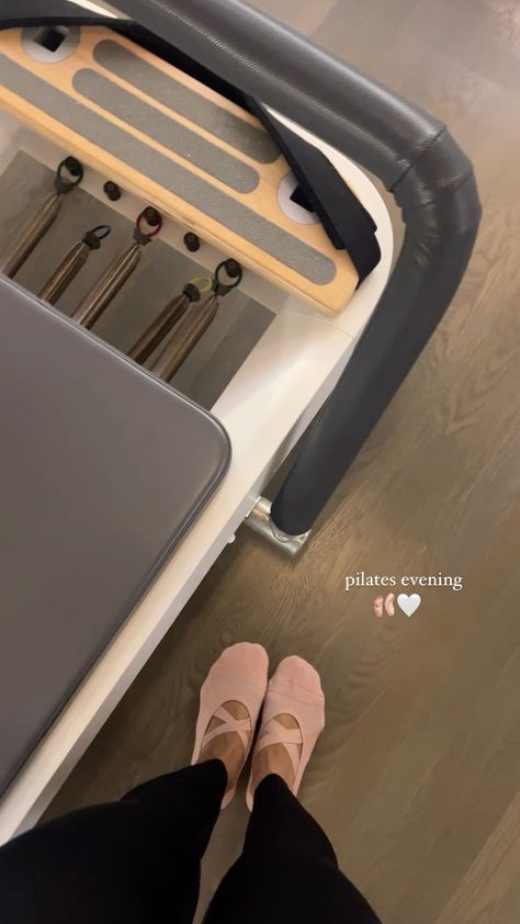 a woman is standing on a treadmill with her feet propped up against the machine