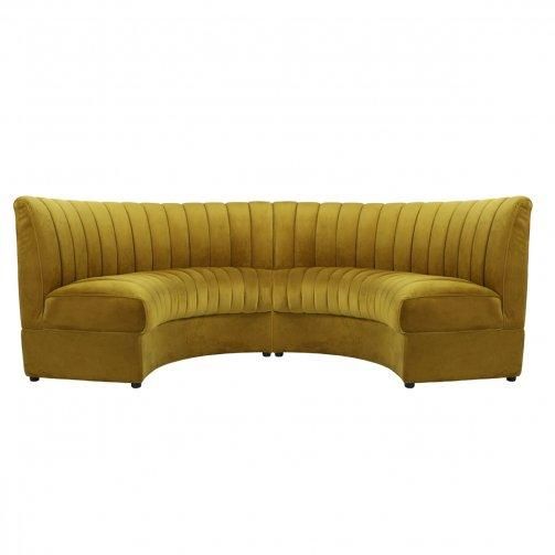 the curved couch is made from yellow velvet and has two legs that are extended to one end