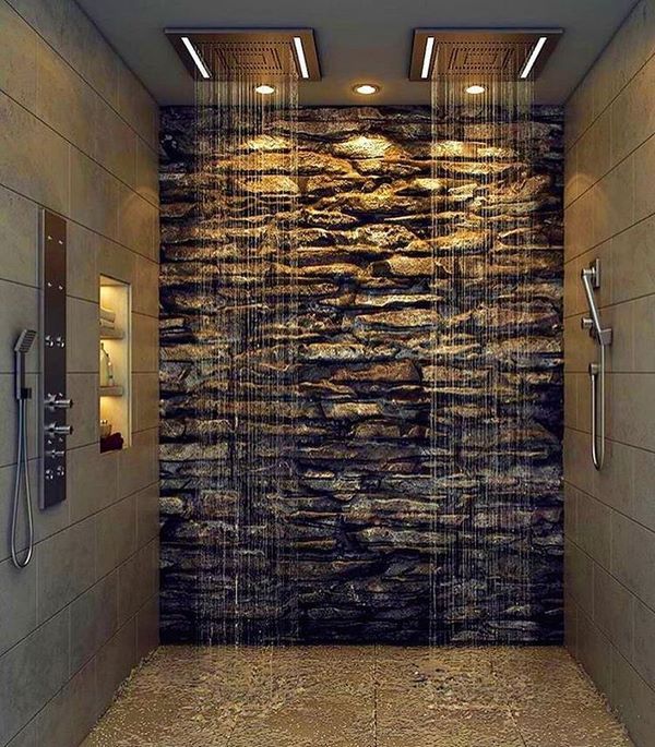 an instagramted photo of a bathroom with rocks on the wall and shower head