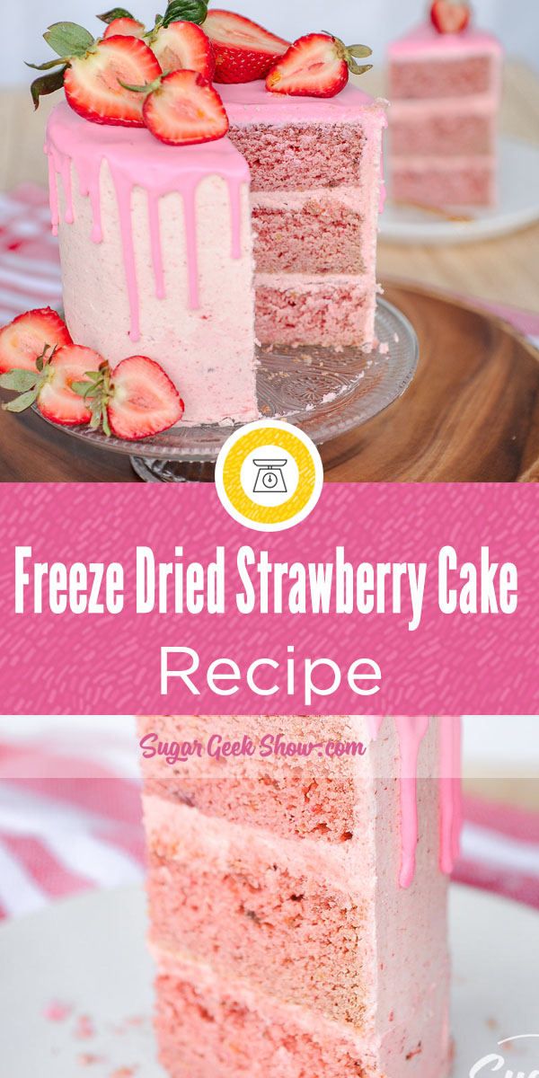 a strawberry cake with pink frosting and fresh strawberries on top that is cut in half